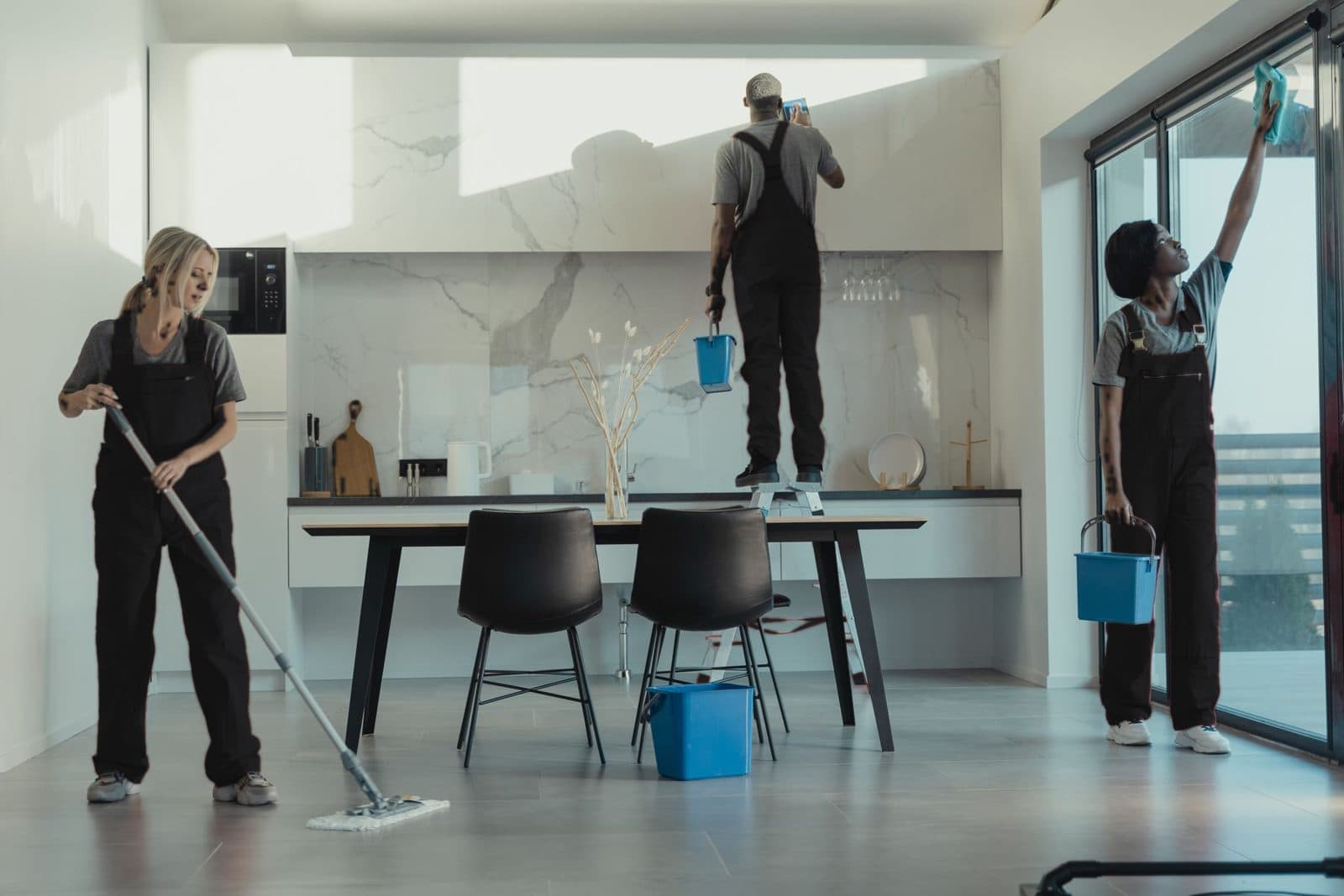 Two cleaners preparing a rental kitchen
